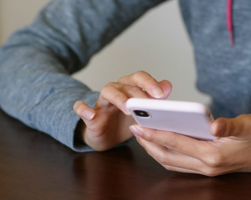 Woman use of mobile phone for online searching